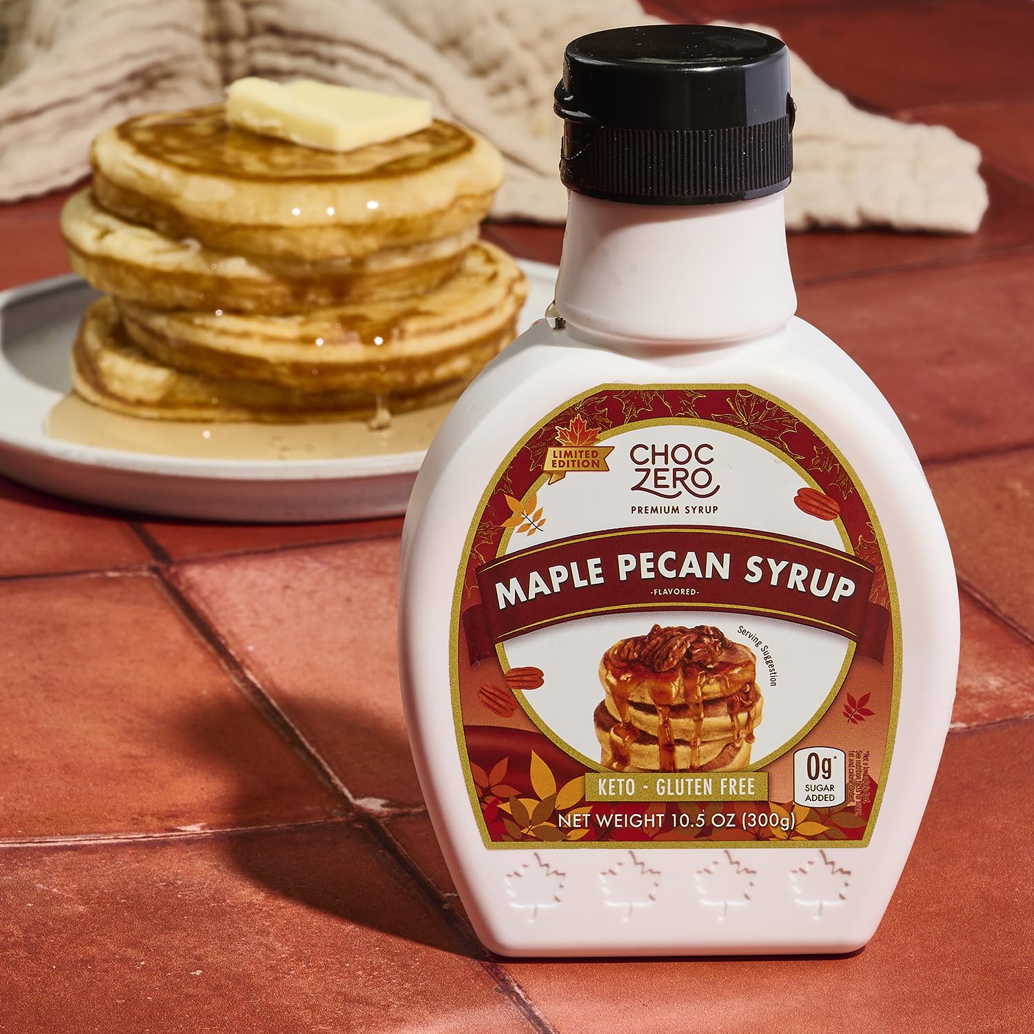 ChocZero Maple Pecan Syrup glass bottle on kitchen counter.