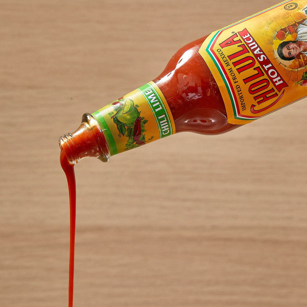 Cholula on kitchen table ready to season meals