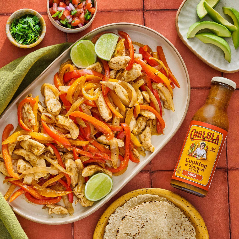 Cholula Fajita Sauce on warm tortillas with toppings ready to roll.