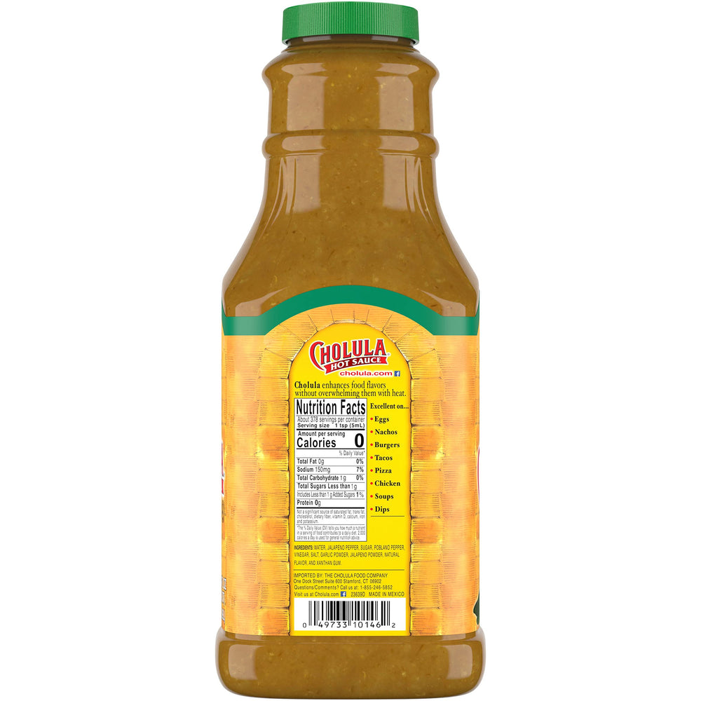 Cholula Green Pepper Hot Sauce being poured over tacos for bold flavor.