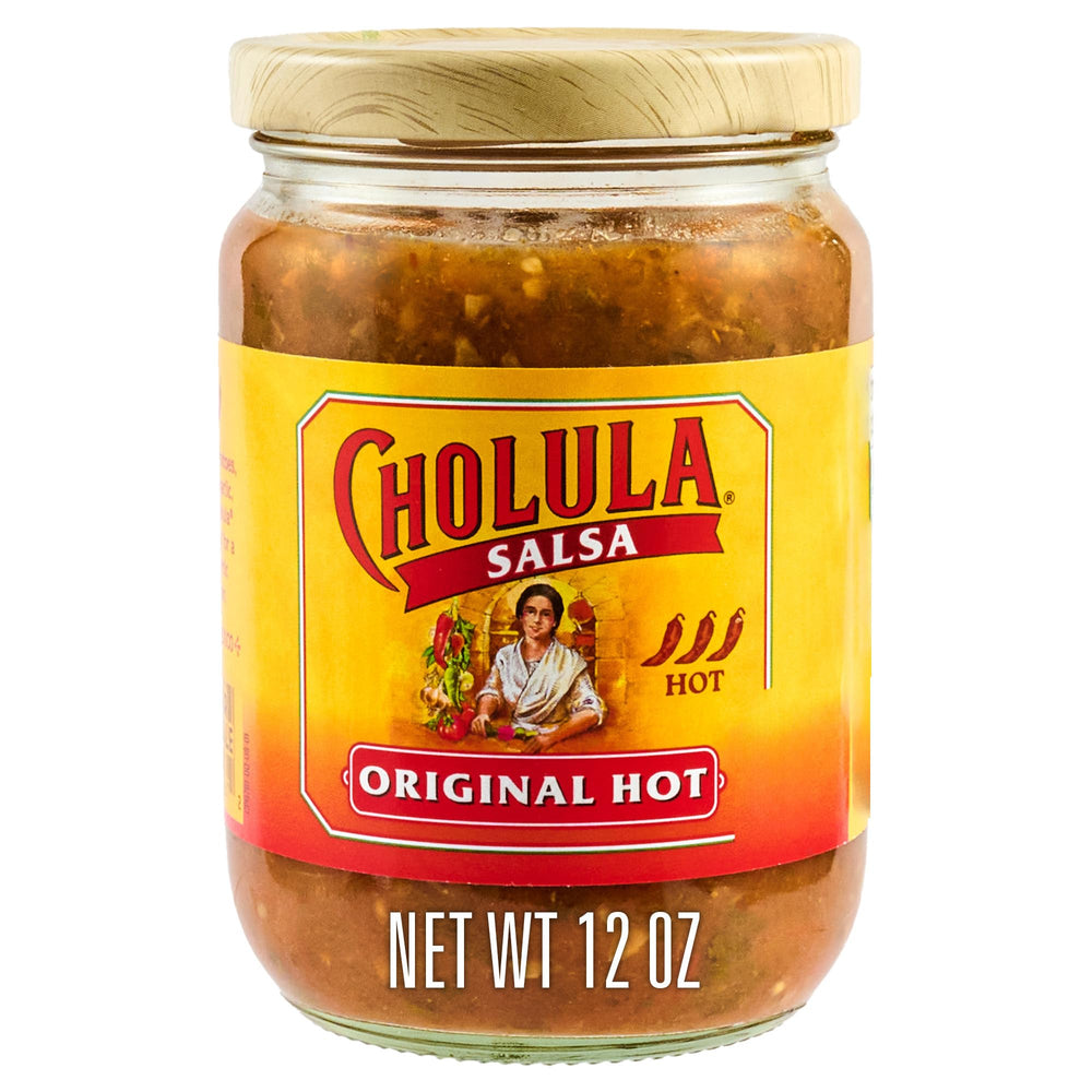 Cholula Original Hot salsa bottle pour adds vibrant heat to tacos.