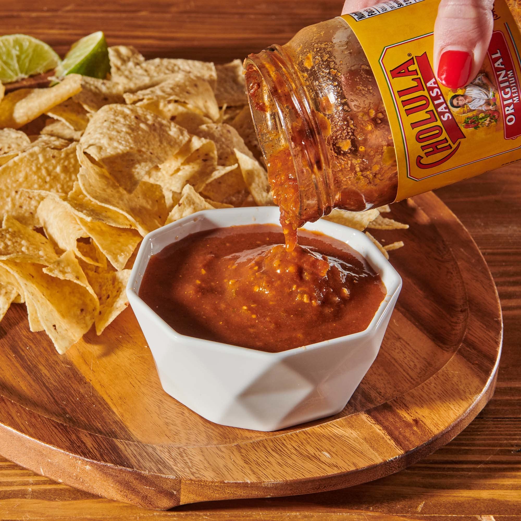 Salsa poured over a bowl of rice and beans with Cholula