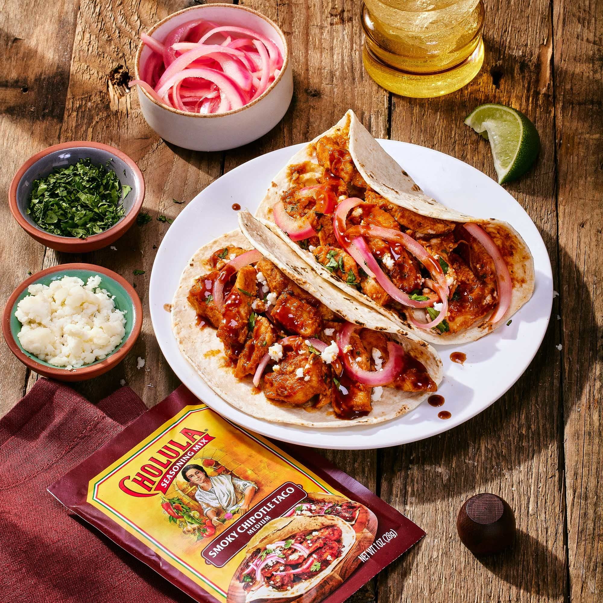 Cholula seasoned chicken tacos plated showing rich color