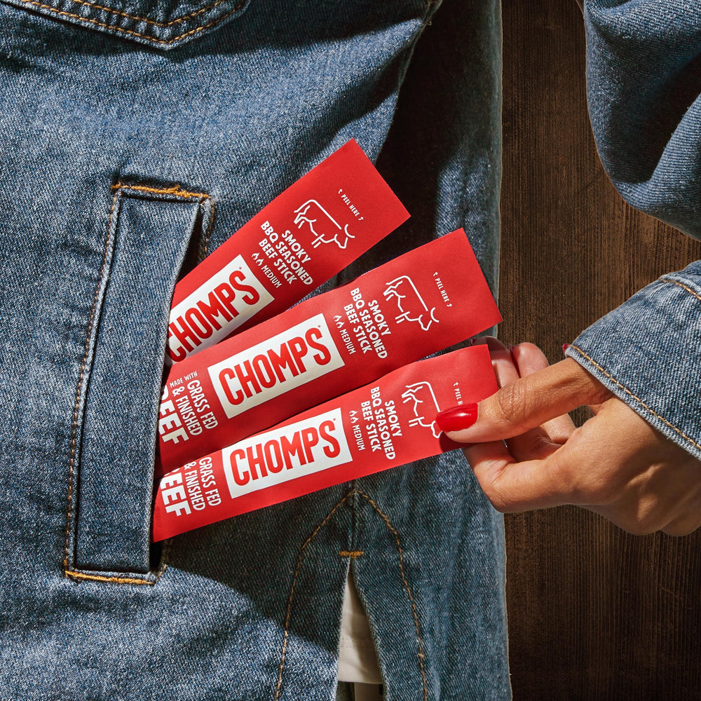 Chomps keto-friendly jerky stick in hand for quick energy.