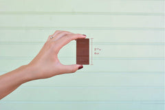 Chuao Chocolatier More Joy dark chocolate close-up, glossy finish and premium texture.