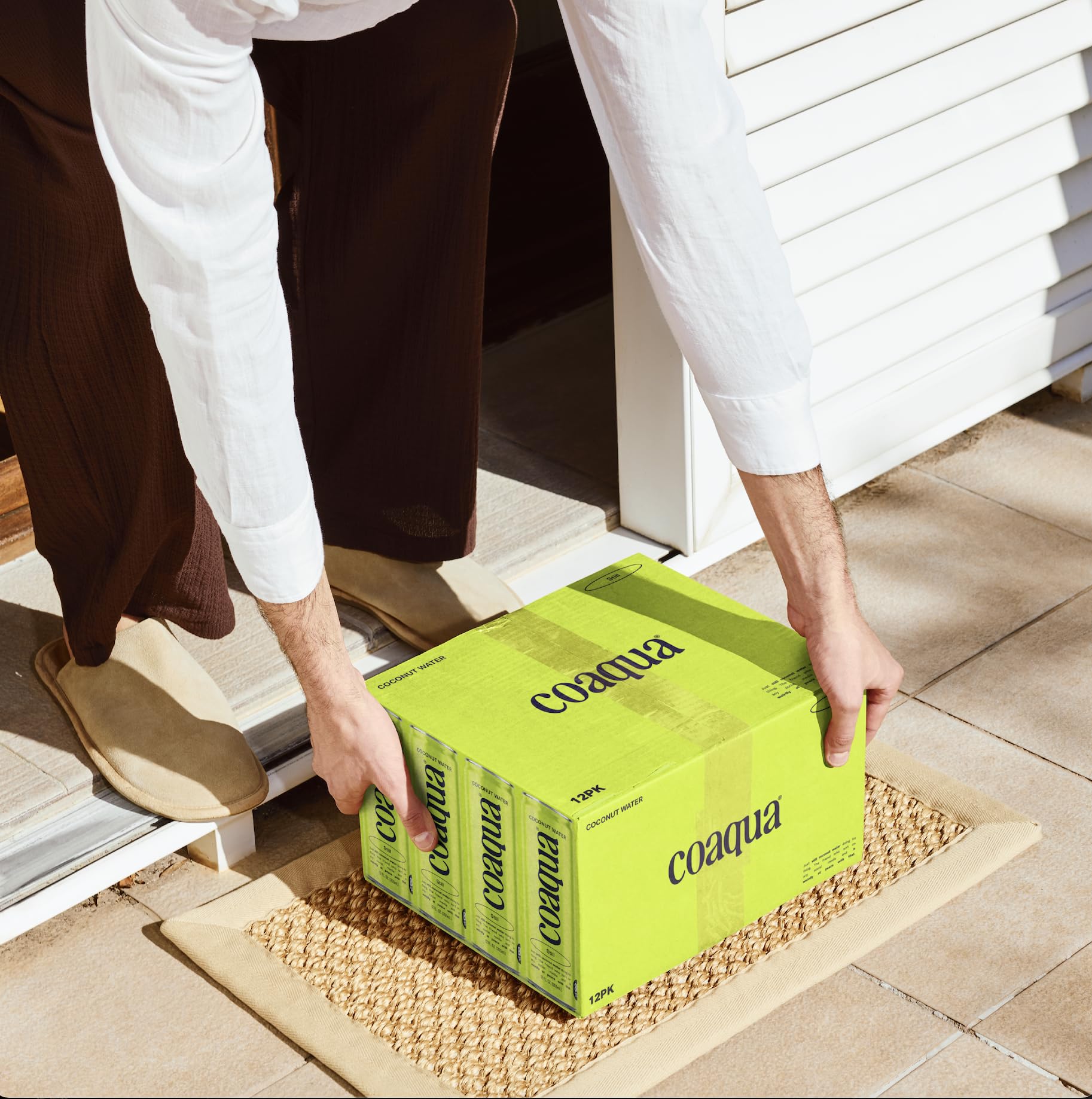 Cold CoAqua coconut water in glass with ice for a refreshing sip.