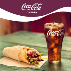 Coca-Cola Cherry Coke being poured into a glass with bright fizz