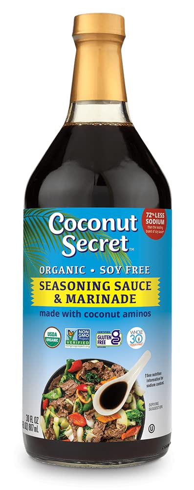 Coconut Secret Coconut Aminos bottle poured over a salad, soy-free flavor option.