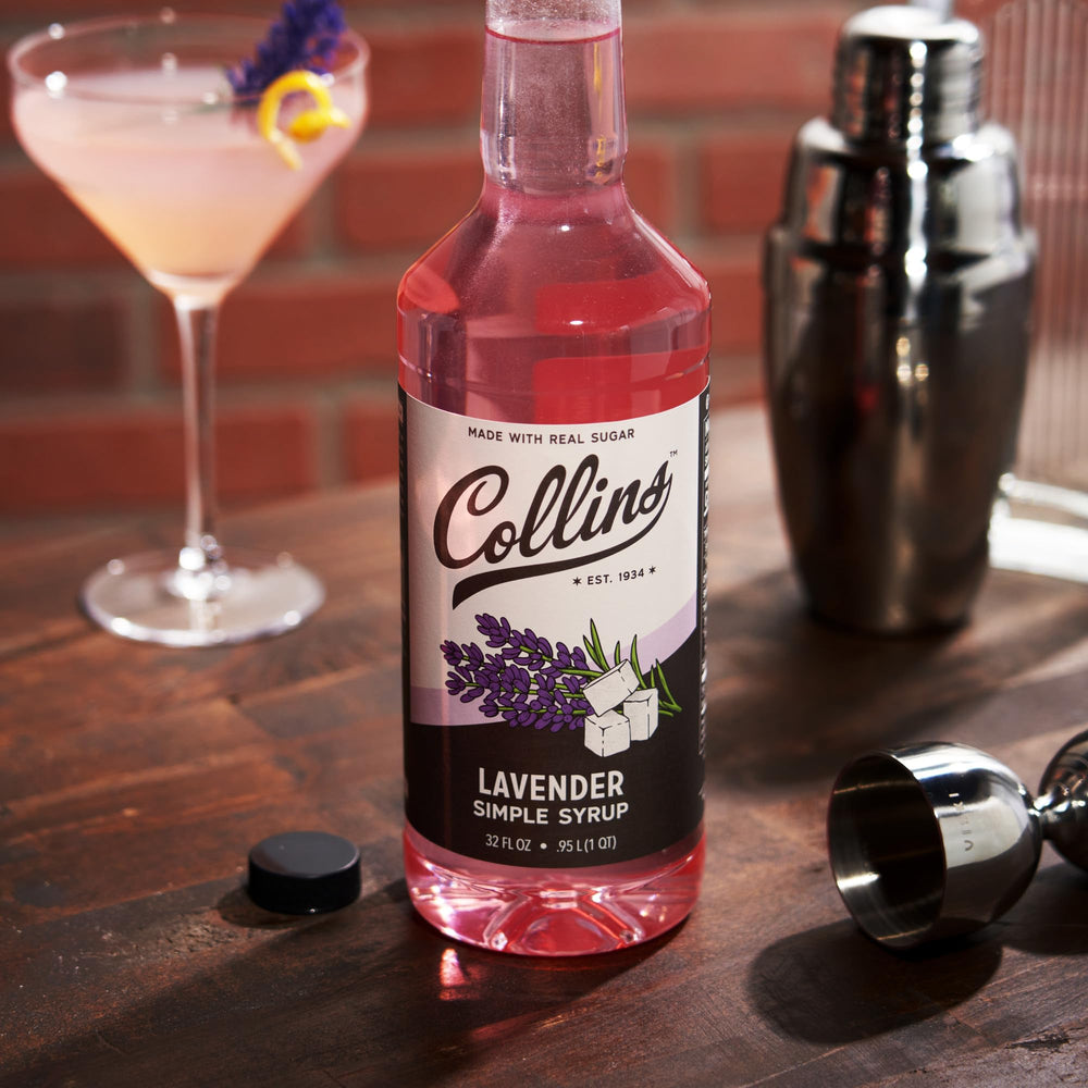 Collins Lavender Syrup next to a lemonade glass for a floral twist