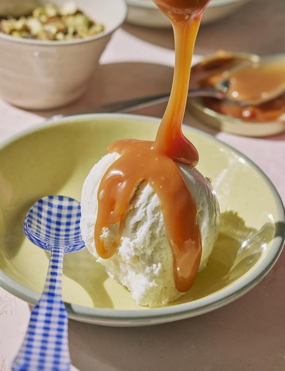 Pouring Coop's Salted Caramel Sauce to show smooth texture