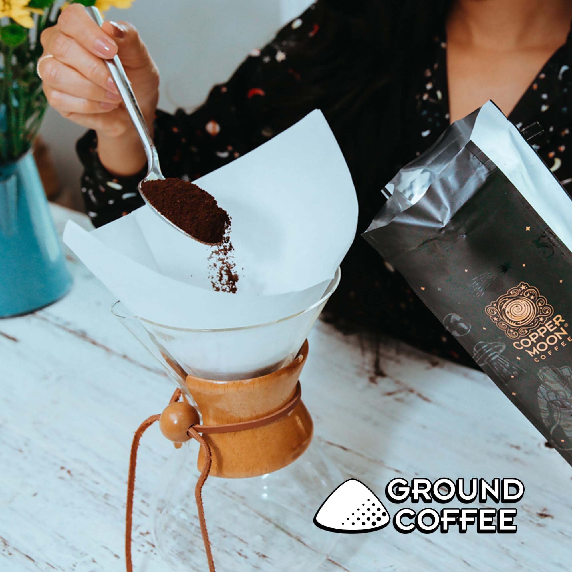Steam rising from Copper Moon Dark Sky coffee being poured for a fresh brew.