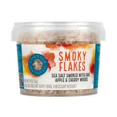 Cornish Sea Salt Co Smoky Flakes tub close-up shows smoky aroma for grilling.