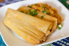 Country Creek Acres corn husk wraps steaming tamales in a pot