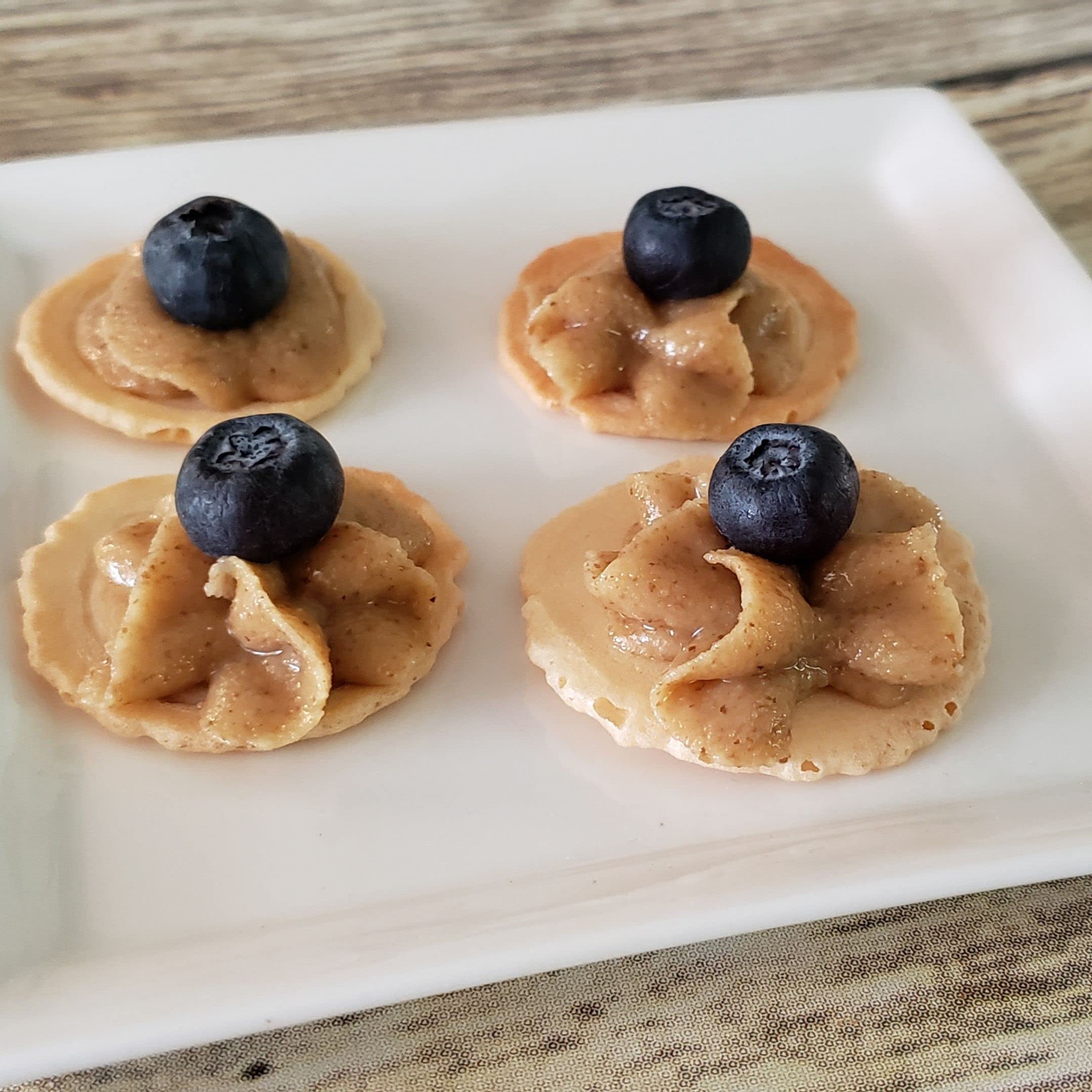 Apple slices topped with CrazyGoNuts walnut butter plain sea salt for a flavorful bite.