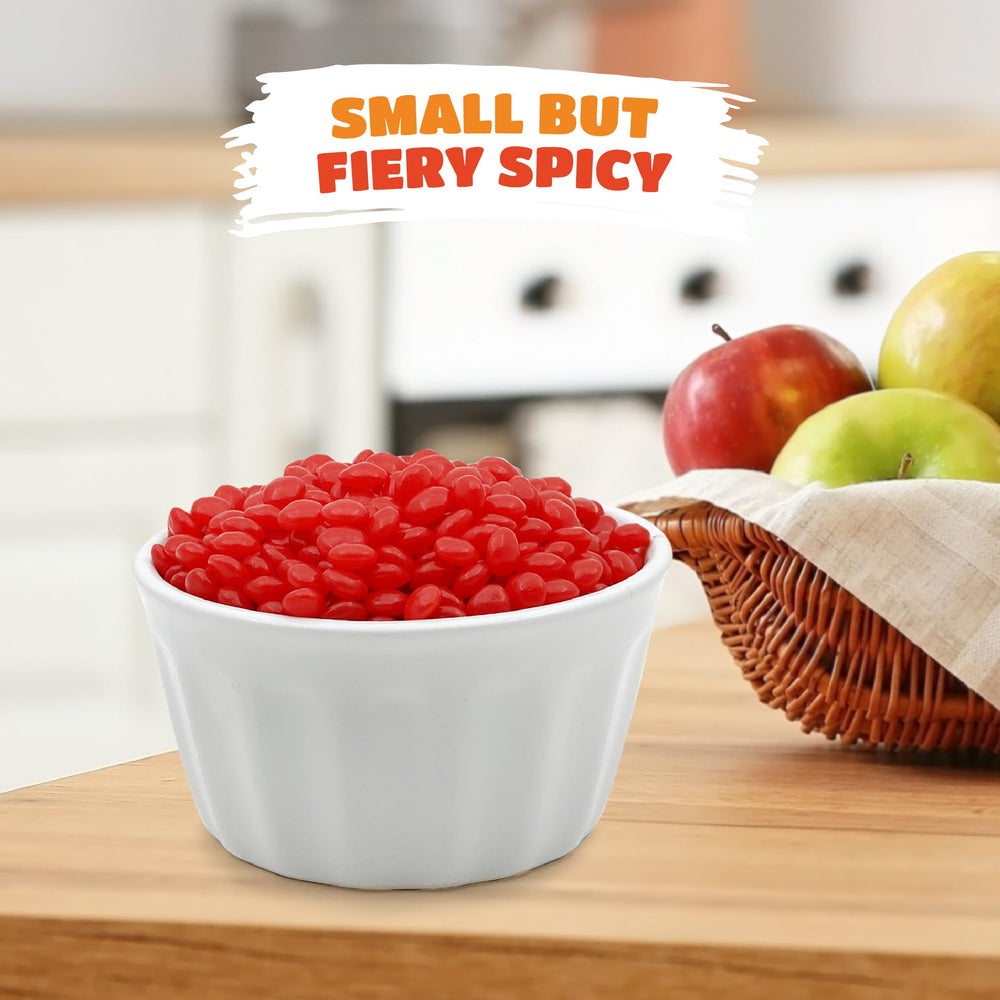 Small red cinnamon pieces sprinkled on desserts for decoration.