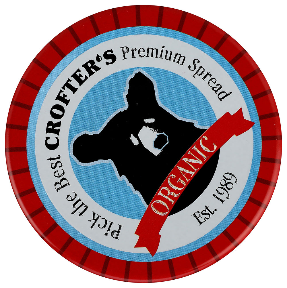 Spoonful of Crofters spread showing smooth, glossy texture.