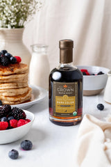 Crown Maple Dark Color being poured over fluffy pancakes.