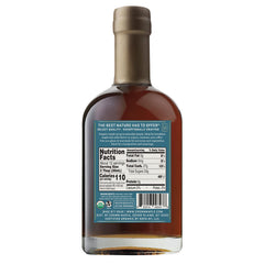 Pouring Crown Maple vanilla-infused maple syrup over pancakes for fragrance.