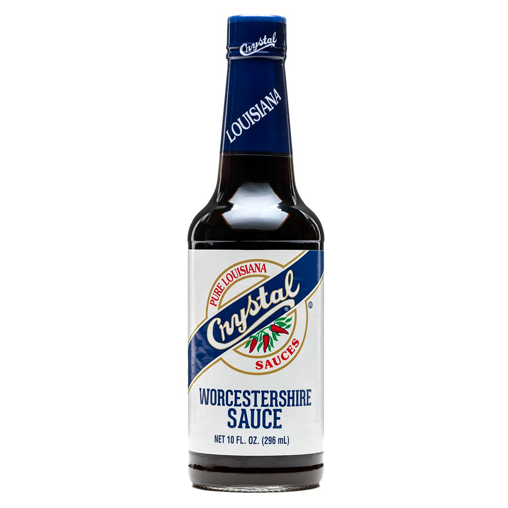 Crystal Worcestershire bottle pouring over steak for savory flavor.