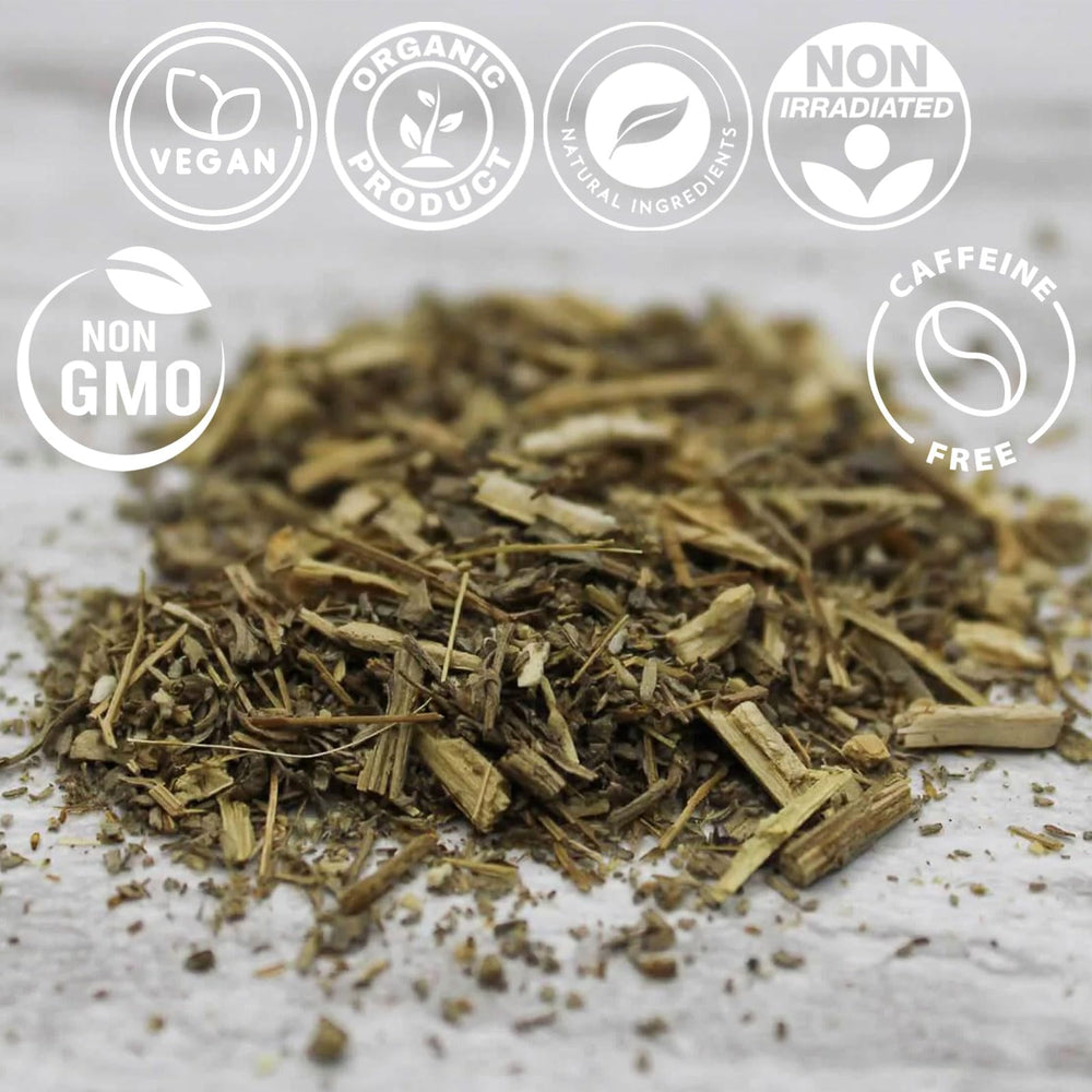 Measuring 1-2 teaspoons of Cure wid Pure wormwood with wooden spoon