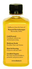 Daana Safflower Oil drizzle over a fresh salad highlighting color.