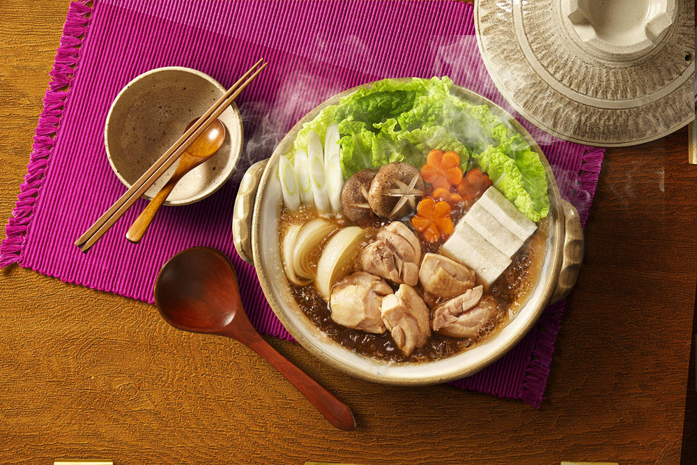 Daisho Nabe family dining scene featuring steaming bowls.