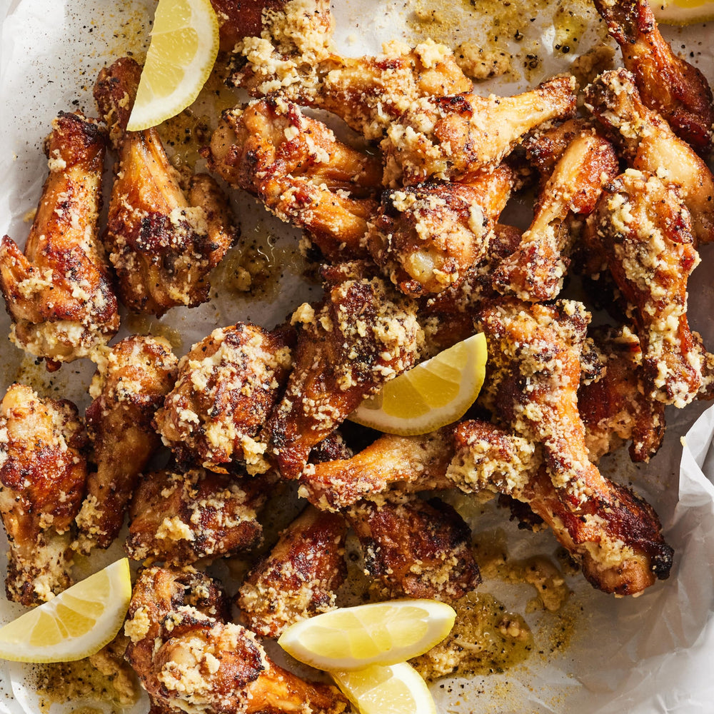 Dalkin & Co Lemon Pepper on kitchen counter with fresh herbs.