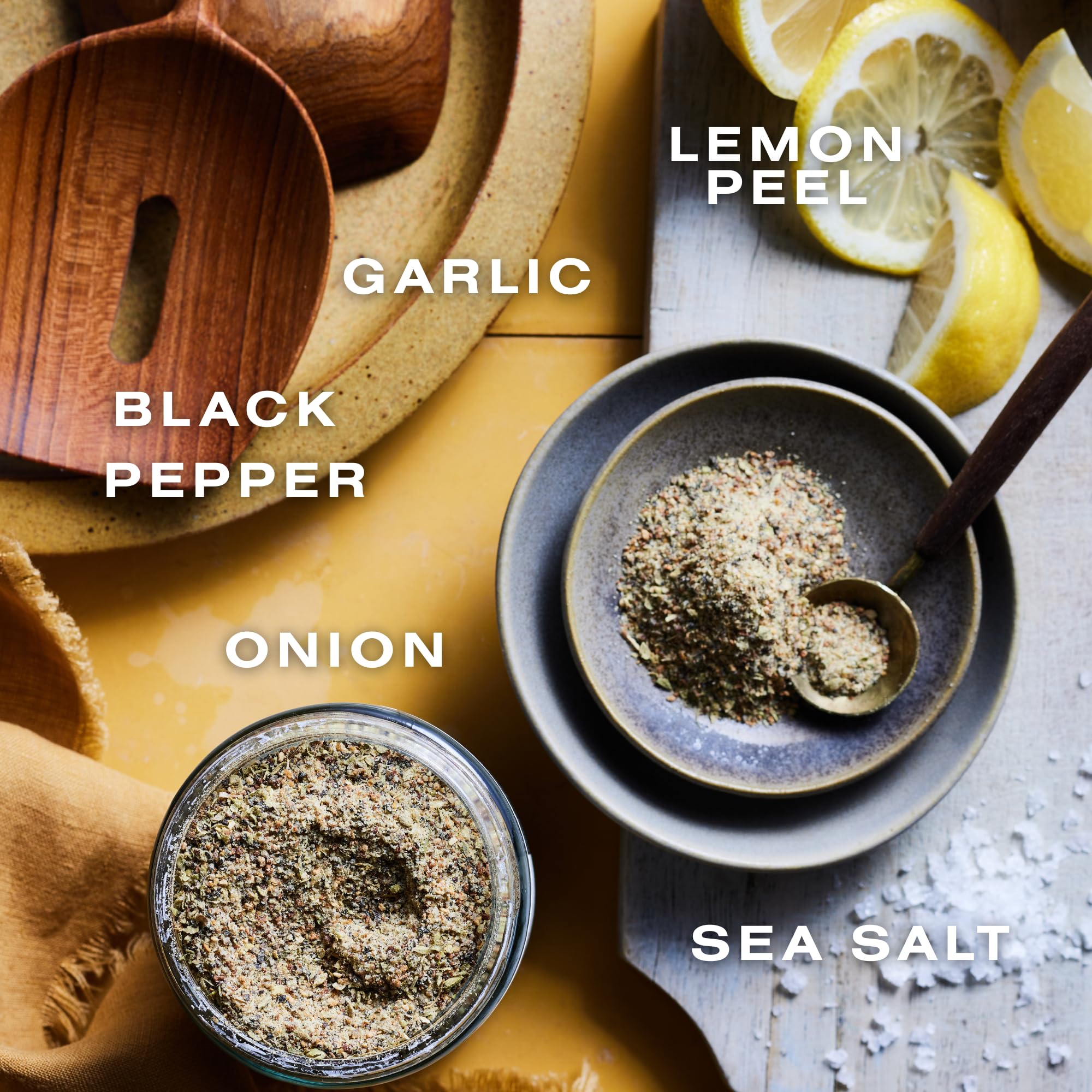 Dalkin & Co Lemon Pepper shaker dispensing seasoning onto dishes.