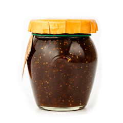 Dalmatia Fig Spread on a cheese board with Brie and Manchego.