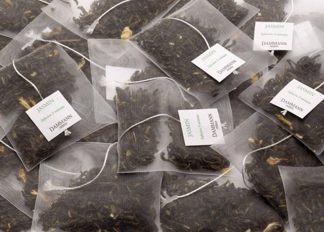 Dammann Freres teabag steeping into a cup with jasmine notes