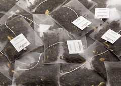 Dammann Freres teabag steeping into a cup with jasmine notes