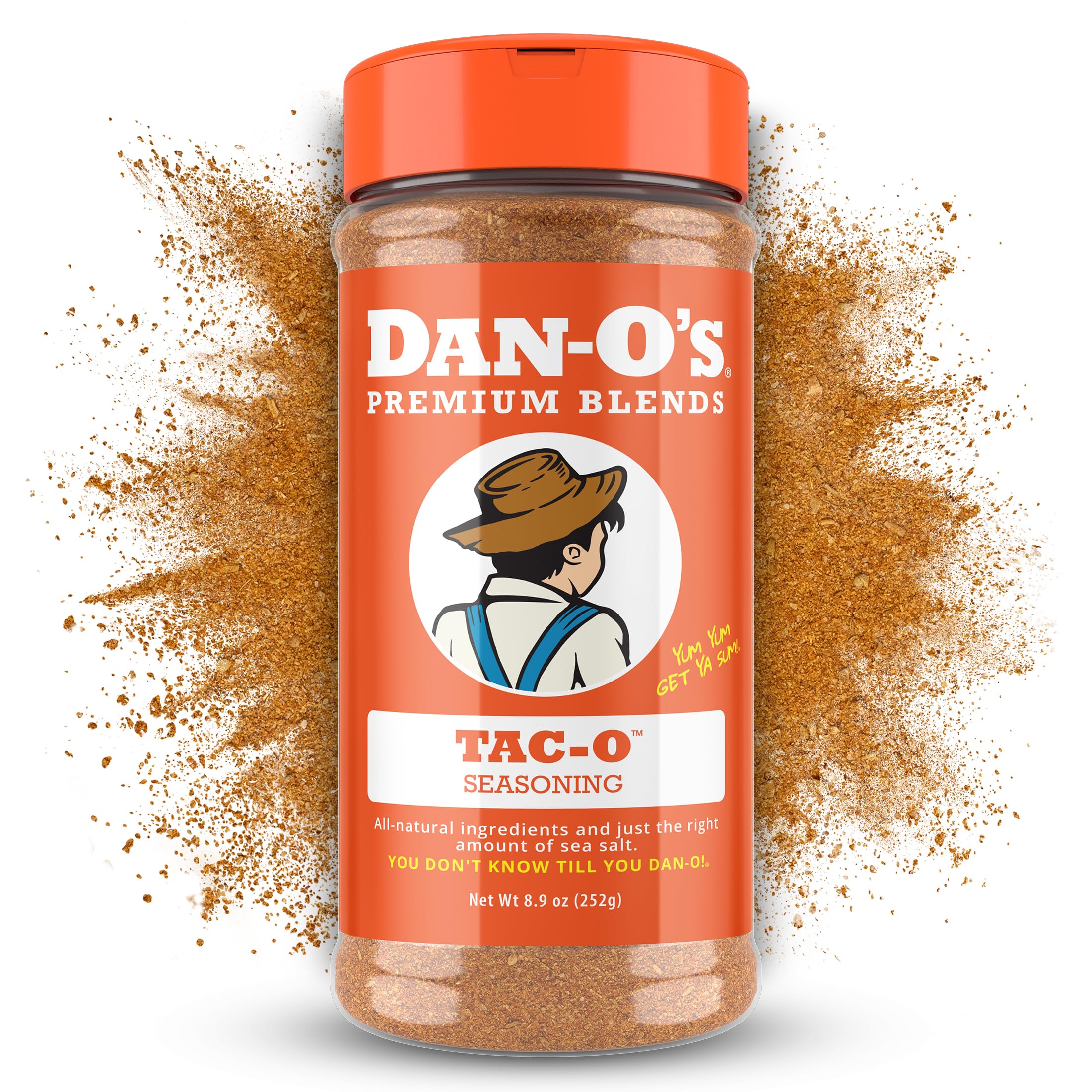 Dan-O's Tac-O Seasoning bottle pouring over sizzling meat for flavor boost