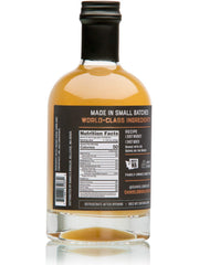 Daniel’s Broiler mixer being poured into a glass for a crisp whiskey sour.