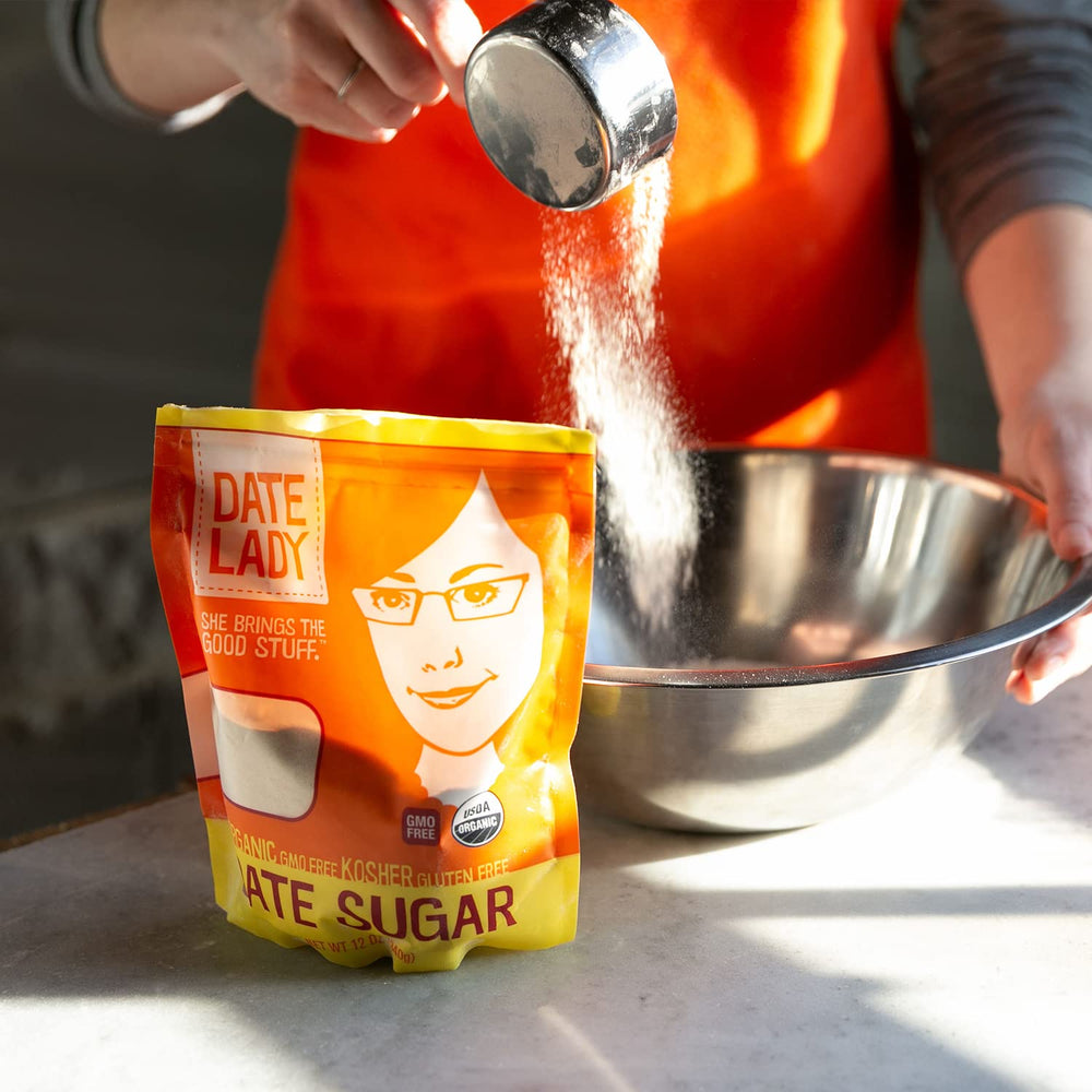 Pouring Date Sugar into a mixing bowl showing even distribution.