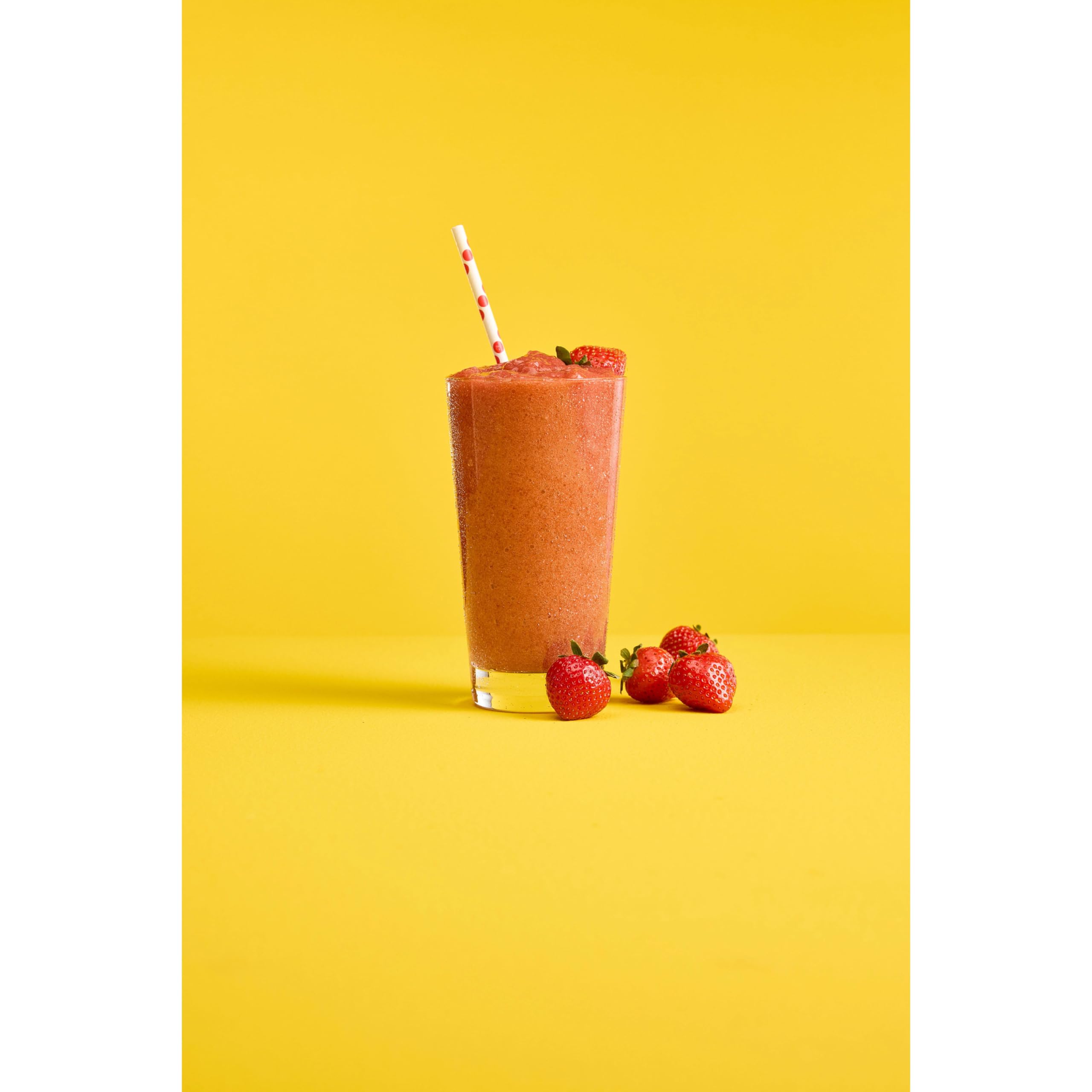 Glass of DaVinci Gourmet Strawberry Bomb Smoothie with fresh fruit garnish.