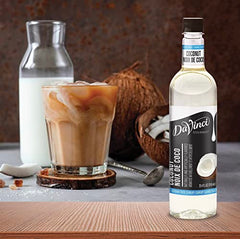 Pouring DaVinci Gourmet Sugar Free Coconut Syrup into a latte for creamy aroma.