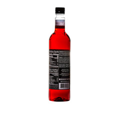 Pouring DaVinci Gourmet Sugar-Free Huckleberry Syrup into a coffee cup.