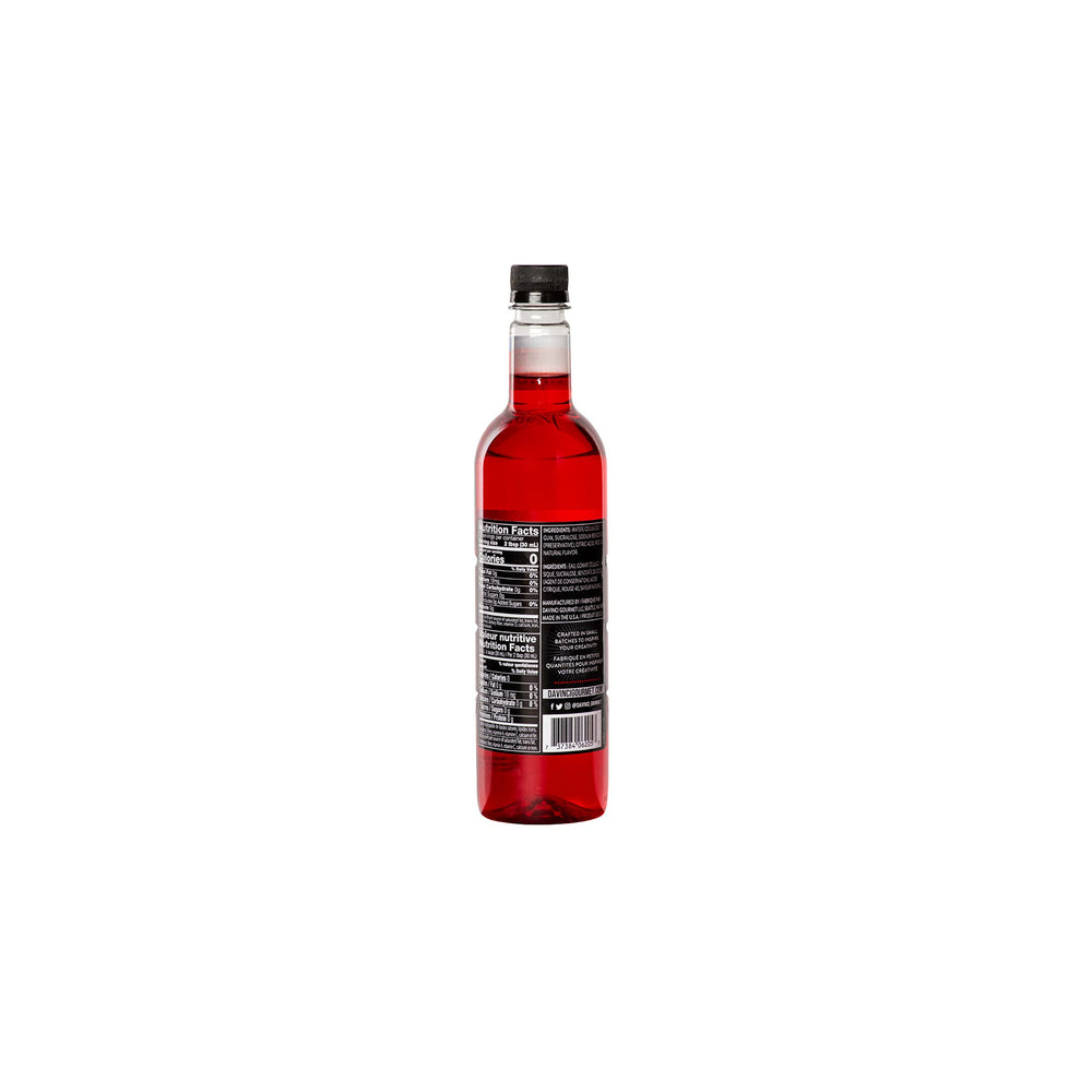 Pouring DaVinci Gourmet Sugar-Free Strawberry Syrup into a cup for flavor.