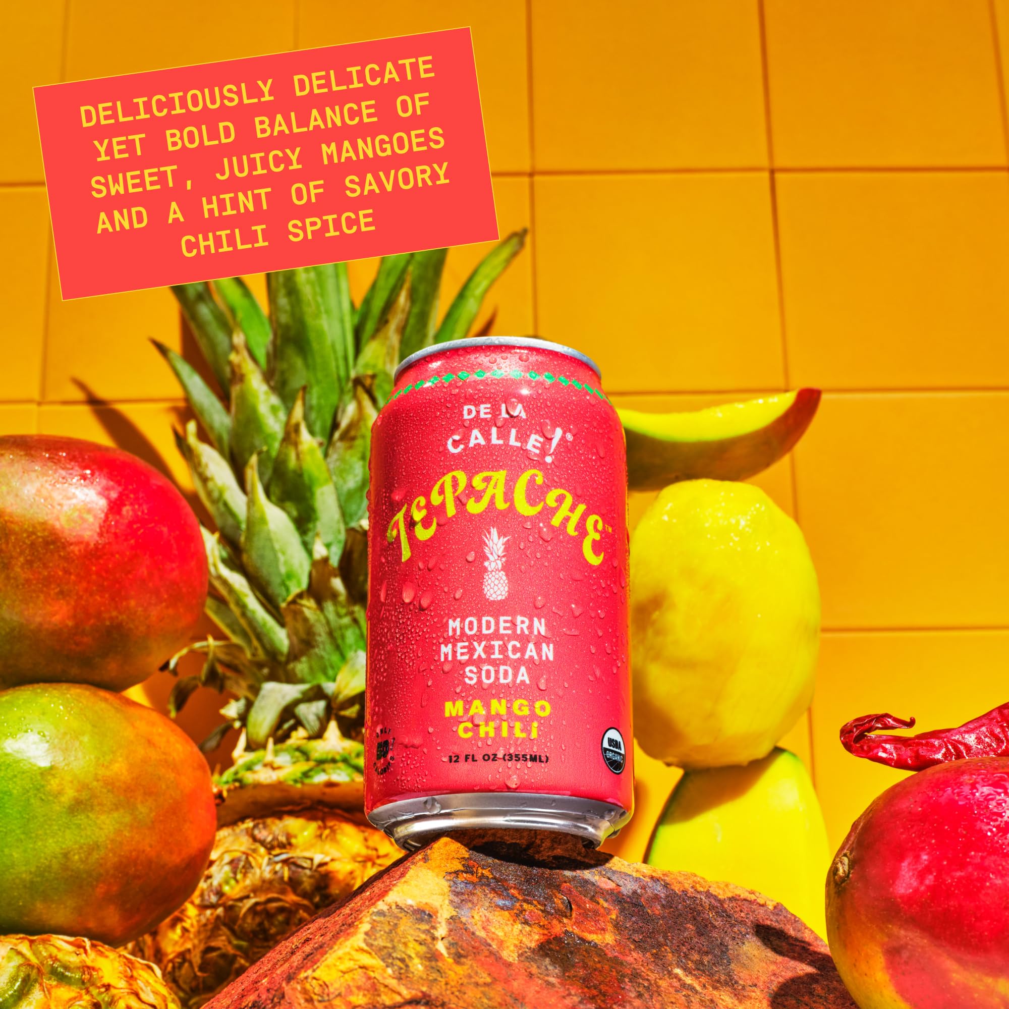 De La Calle Tepache bottle with tropical mango slices nearby.