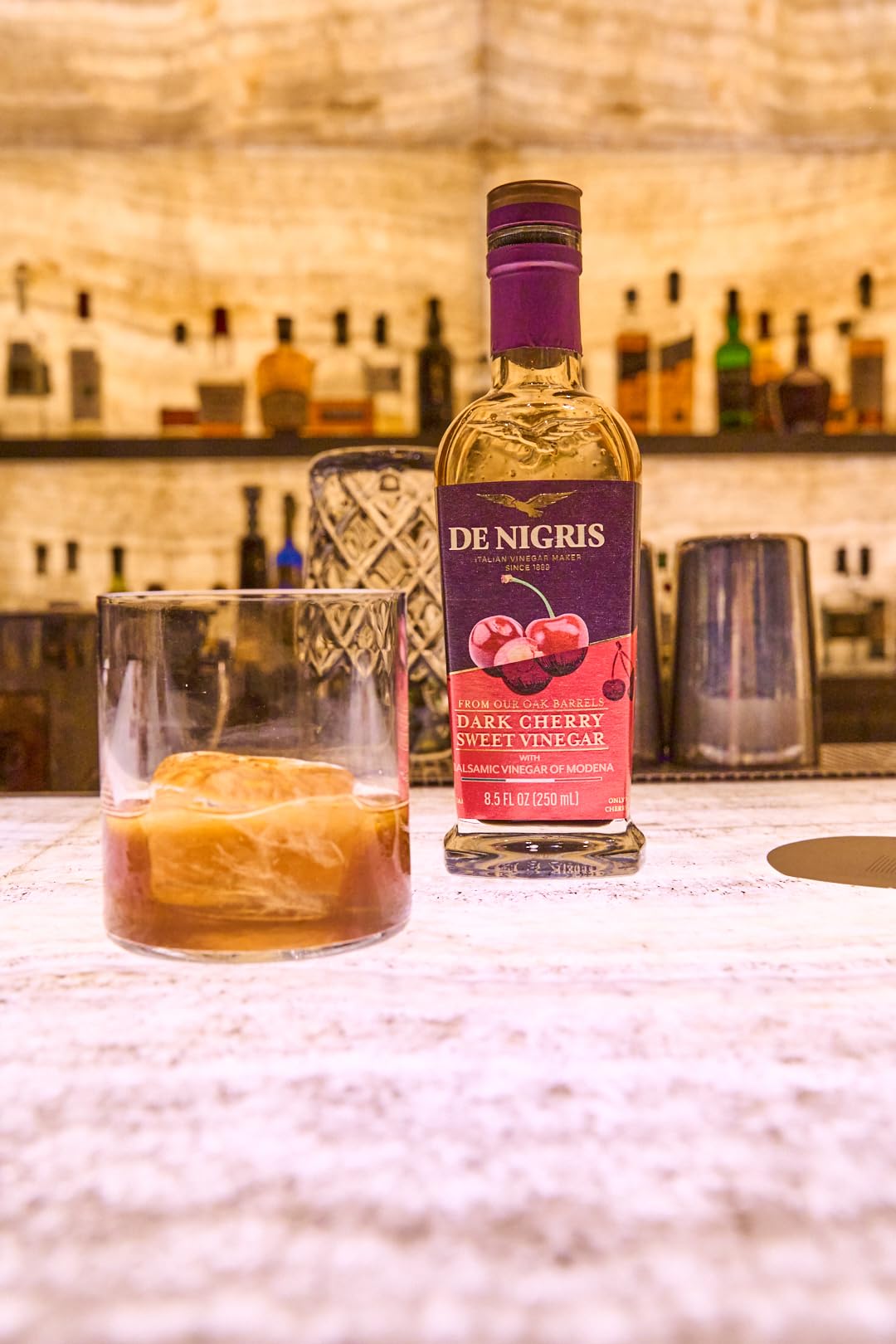 De Nigris bottle pouring to illustrate versatile kitchen staple in recipes.