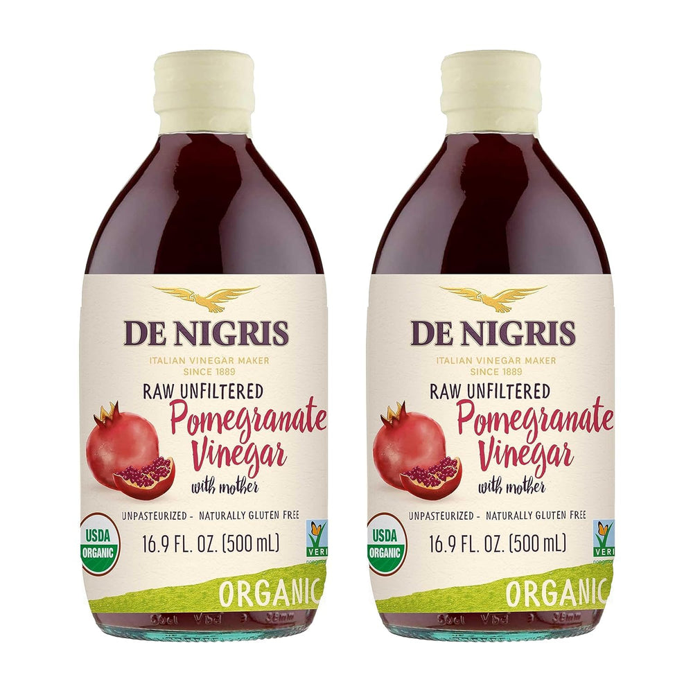 De Nigris Organic Pomegranate Vinegar bottle pouring over a fresh salad for bright flavor