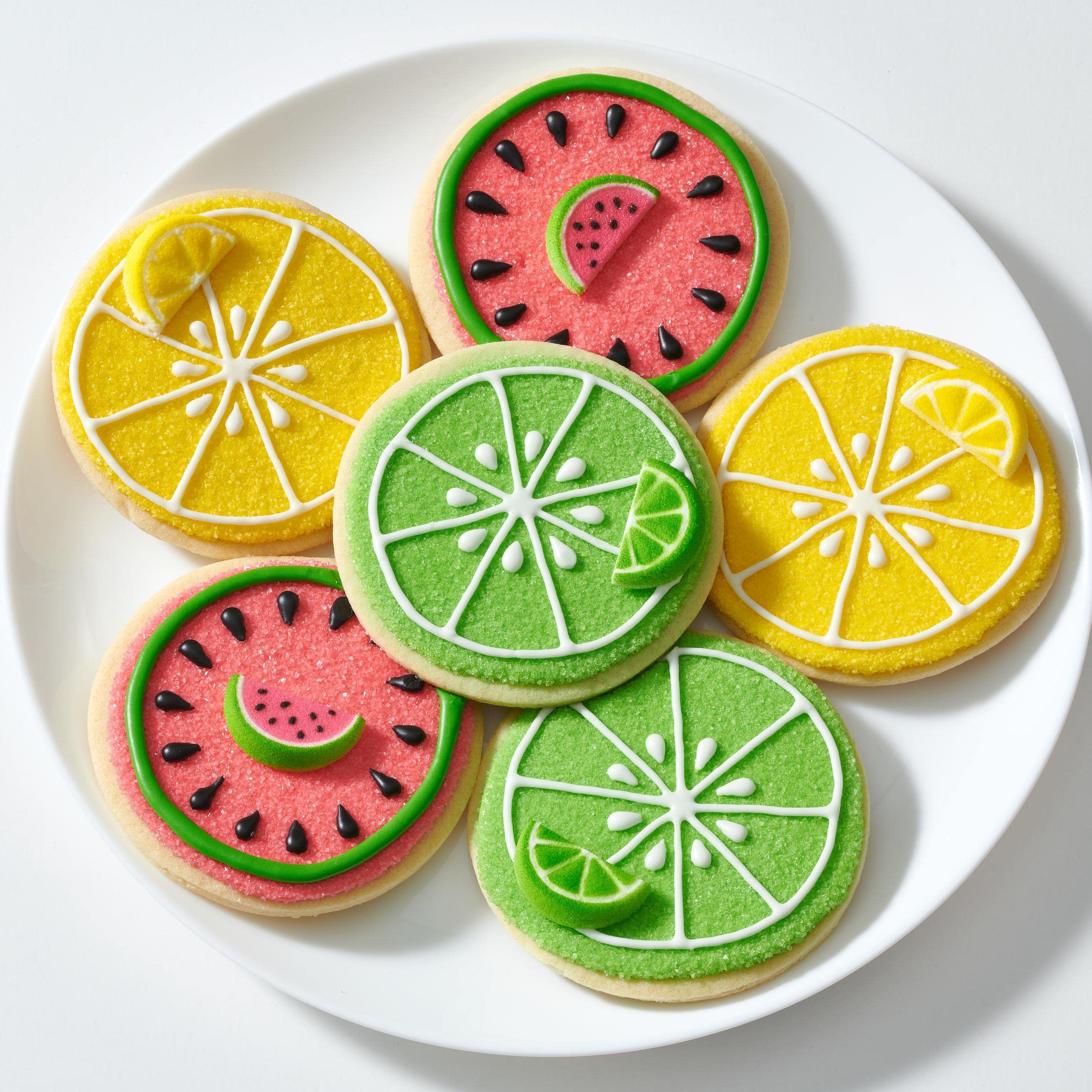 Sanding sugar on cookies with DecoPac yellow decorative sparkle.