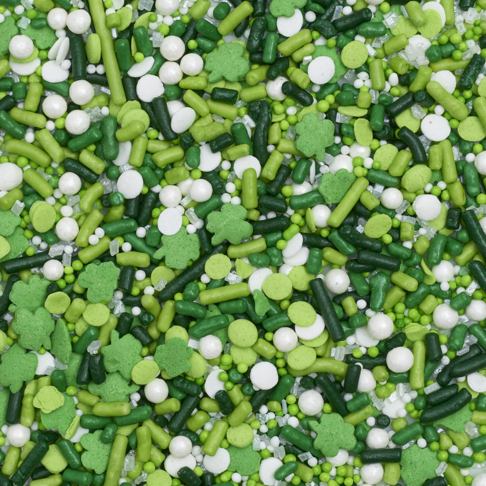 Green and white DecoPac sprinkles decorates a cake for festive flair.