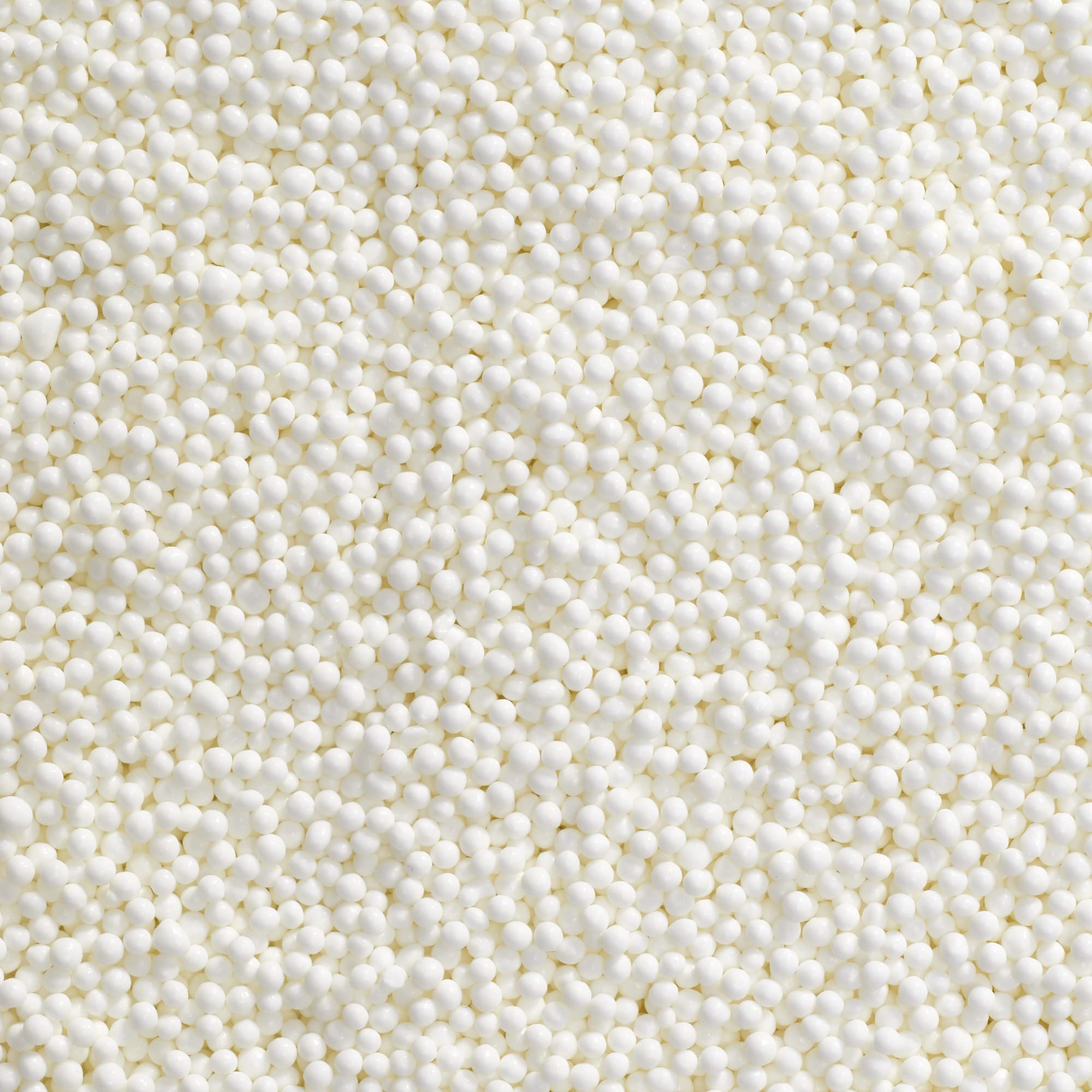 DecoPac white nonpareils on a frosted cake for festive detail