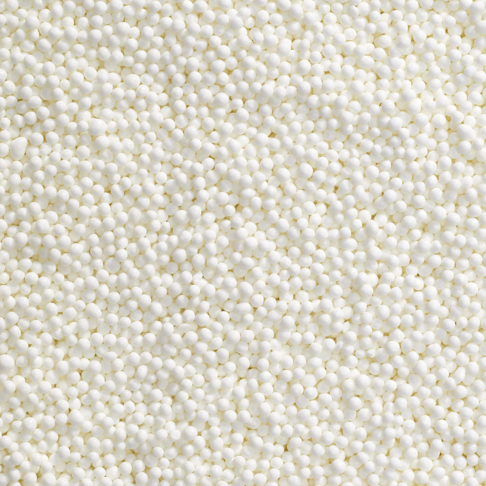DecoPac white nonpareils on a frosted cake for festive detail
