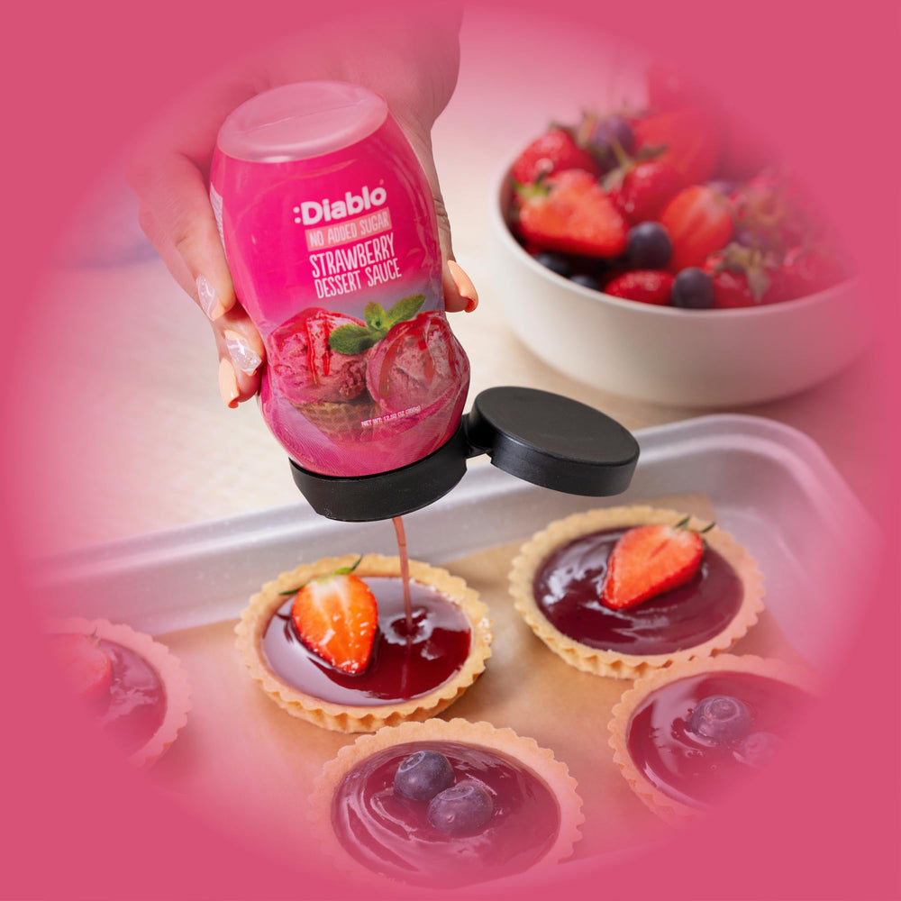 Diablo Strawberry Dessert Sauce being poured over pancakes for fruity drizzle