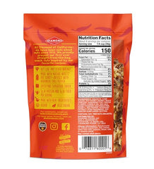 Diamond of California hot honey walnuts on a wooden board, ideal for a quick protein snack.