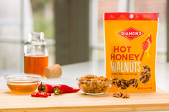 Diamond of California hot honey walnuts in a snack bowl, pairs with cheese or crackers.