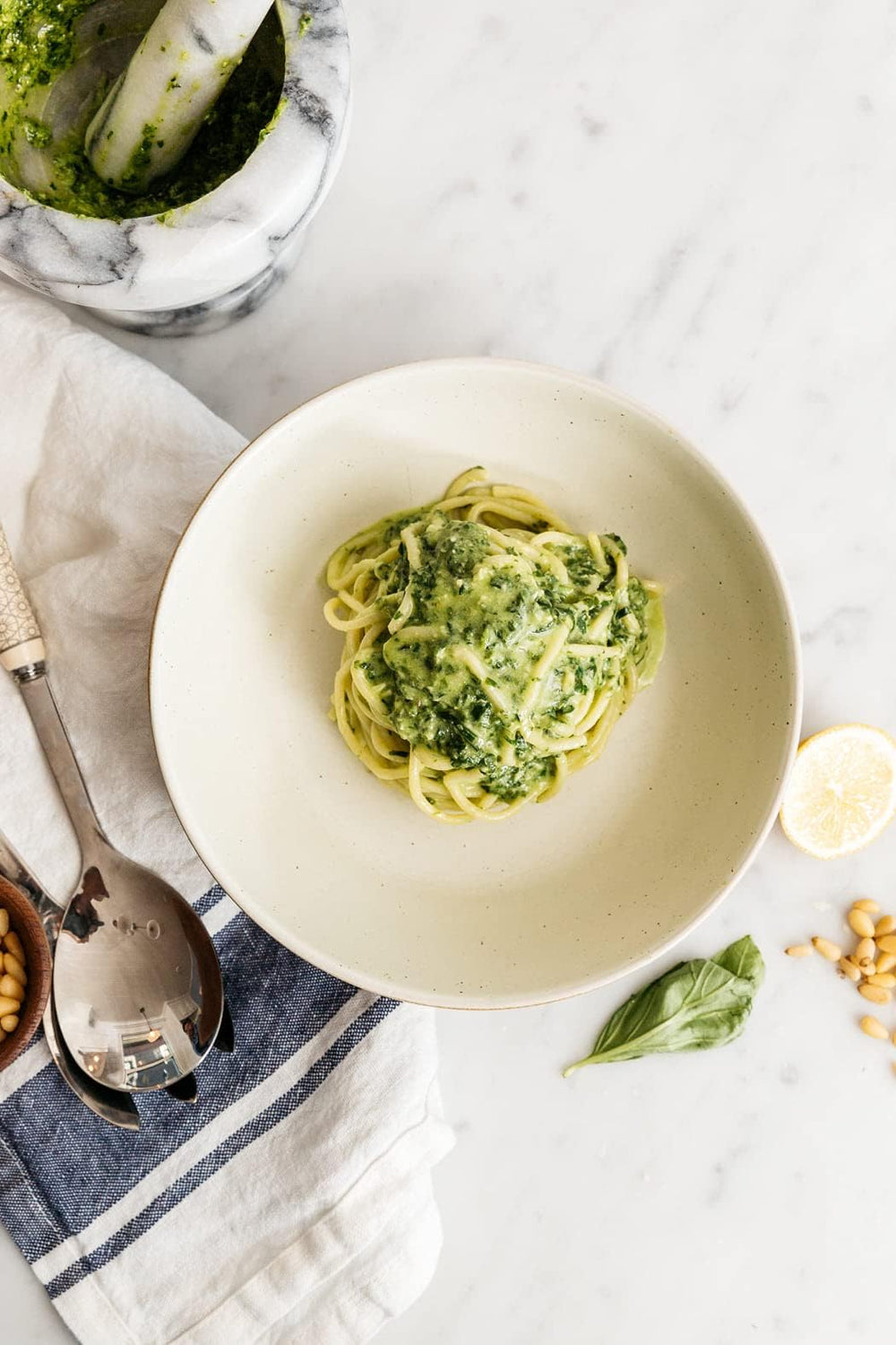 Diamond of California pine nuts on a dish of pesto for creamy texture.