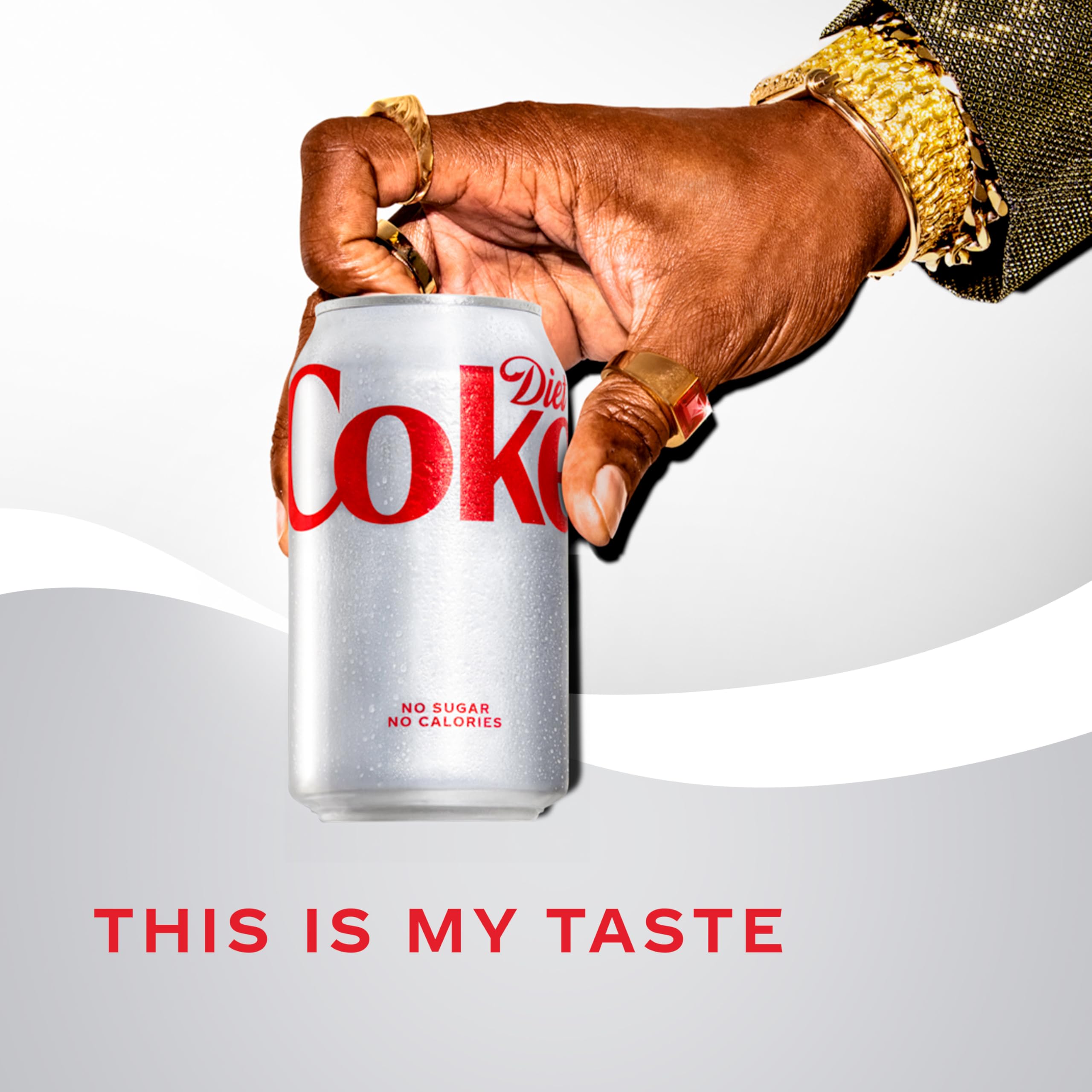 Diet Coke bottle poured into glass with ice.